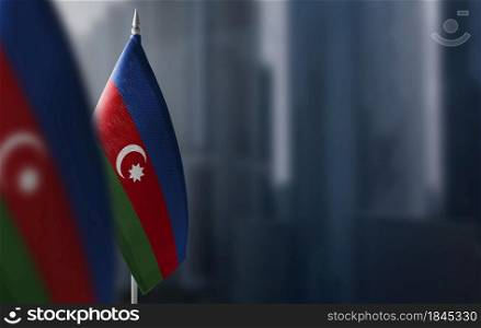 Small flags of Azerbaijan on a blurry background of the city.. Small flags of Azerbaijan on a blurry background of the city