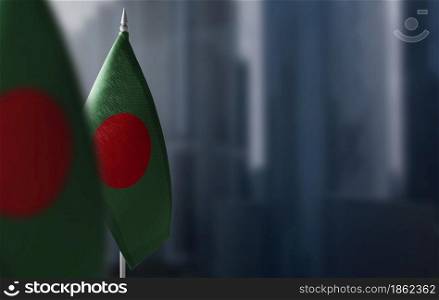 Small flags of Bangladesh on a blurry background of the city.. Small flags of Bangladesh on a blurry background of the city