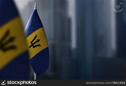 Small flags of Barbados on a blurry background of the city.. Small flags of Barbados on a blurry background of the city