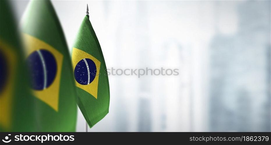 Small flags of Brazil on a blurry background of the city.. Small flags of Brazil on a blurry background of the city