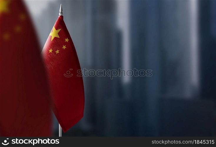 Small flags of China on a blurry background of the city.. Small flags of China on a blurry background of the city