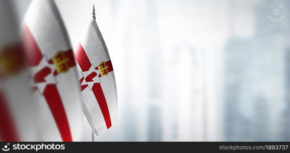 Small flags of Northern Ireland on a blurry background of the city.. Small flags of Northern Ireland on a blurry background of the city