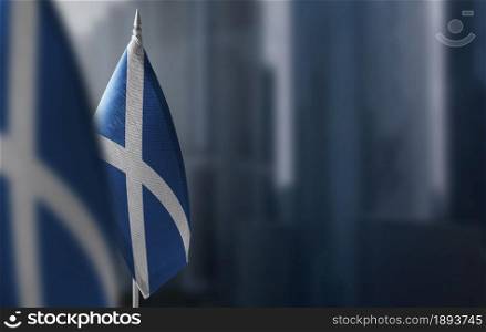 Small flags of Scotland on a blurry background of the city.. Small flags of Scotland on a blurry background of the city