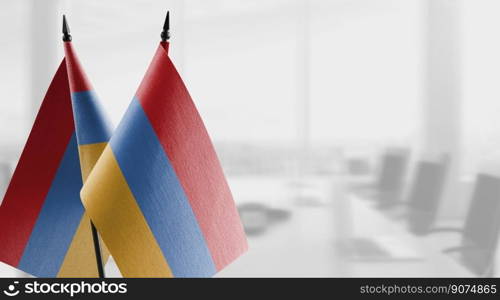 Small flags of the Armenia on an abstract blurry background.. Small flags of the Armenia on an abstract blurry background