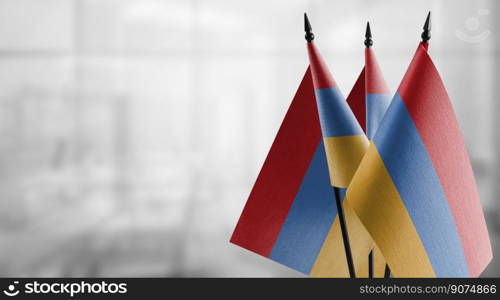 Small flags of the Armenia on an abstract blurry background.. Small flags of the Armenia on an abstract blurry background