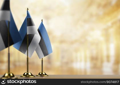 Small flags of the Estonia on an abstract blurry background.. Small flags of the Estonia on an abstract blurry background