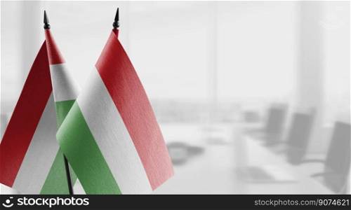 Small flags of the Hungary on an abstract blurry background.. Small flags of the Hungary on an abstract blurry background