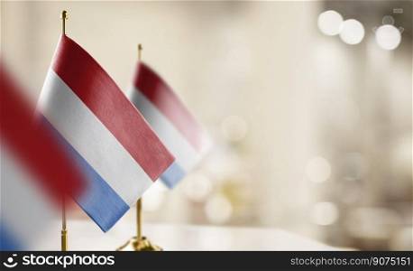 Small flags of the Netherlands on an abstract blurry background.. Small flags of the Netherlands on an abstract blurry background
