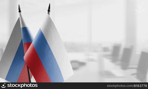 Small flags of the Russia on an abstract blurry background.. Small flags of the Russia on an abstract blurry background