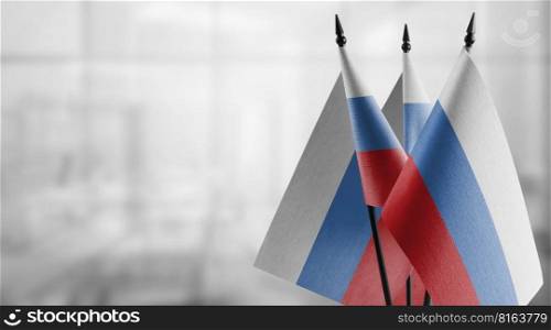 Small flags of the Russia on an abstract blurry background.. Small flags of the Russia on an abstract blurry background