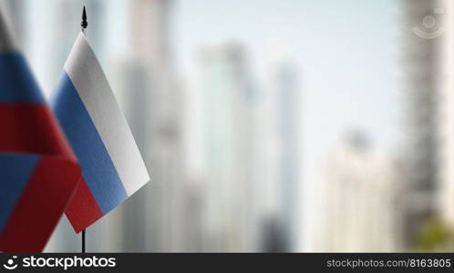 Small flags of the Russia on an abstract blurry background.. Small flags of the Russia on an abstract blurry background
