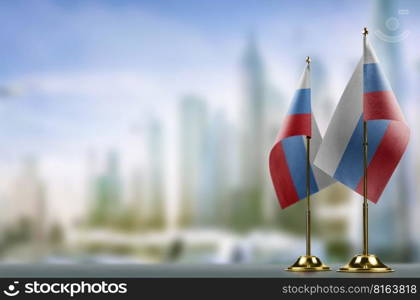 Small flags of the Russia on an abstract blurry background.. Small flags of the Russia on an abstract blurry background