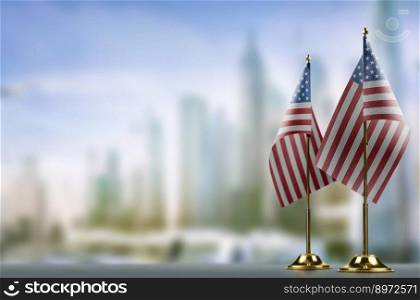 Small flags of the USA on an abstract blurry background.. Small flags of the USA on an abstract blurry background