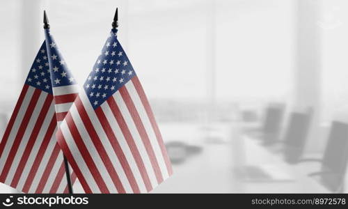 Small flags of the USA on an abstract blurry background.. Small flags of the USA on an abstract blurry background