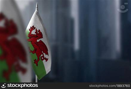 Small flags of Wales on a blurry background of the city.. Small flags of Wales on a blurry background of the city