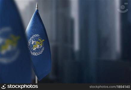 Small flags of World Health Organization WHO on a blurry background of the city.. Small flags of World Health Organization WHO on a blurry background of the city