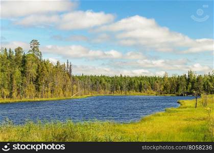 Small forest lake in Karelia, cloudy sky