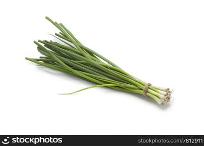 Small fresh green spring onions on white background