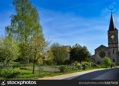 Small garden and old church in a small village. Small garden and old church in a small village near lake madine in the department of meuse in France