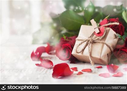 Small gift or present in natural paper with small heart and roses, love or valentine’s day concept