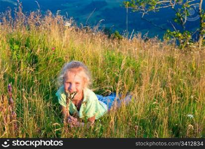 Small girl in mountain wild grasses admire on yellow Swallowtail butterfly (last sunset light)