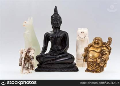 small gods - statuettes of different gods on grey background