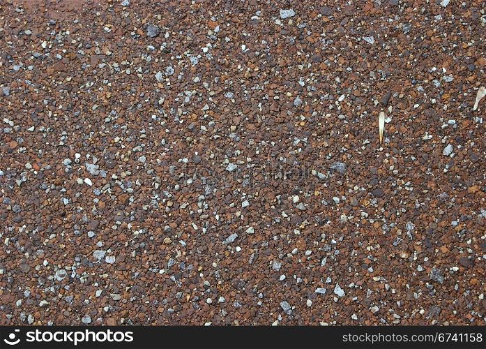 Small gravel and rust layer as background