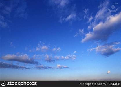 Small Gray Clouds In A Clear Blue Sky