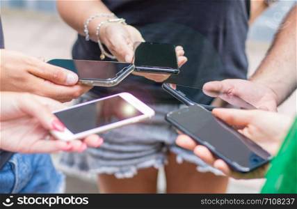 small group of people using cellphones together
