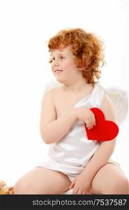 Small happy cupid sits with heart in a hand, isolated
