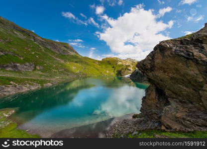 Small high mountain lake with transparent