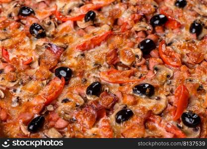 Small homemade vegetable pizza with addition of tomatoes, olives and herbs on a dark conkrete table. Homemade vegetable pizza with addition of tomatoes, olives and herbs