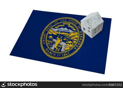 Small house on a flag - Living or migrating to Nebraska