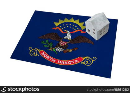 Small house on a flag - Living or migrating to North Dakota