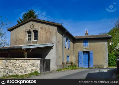Small house with blue shutters . Small house with blue shutters in a small village near the lake of madine in the department of the meuse in France