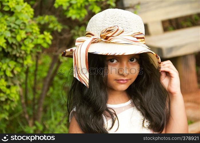 Small Indian girl wearing round fancy cap looking at camera, Pune. Small Indian girl wearing round fancy cap looking at camera, Pune.