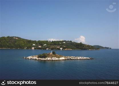Small island close to Greek island Skiathos at Mediterranean sea