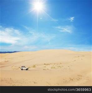 small jeep in sand desert