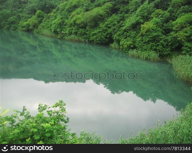 Small lake between the caucasus mountains summertime