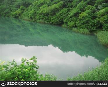 Small lake between the caucasus mountains summertime