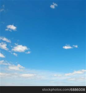 Small light clouds in bright blue sky