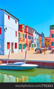 Small market square by canal in Burano, Venice, Italy