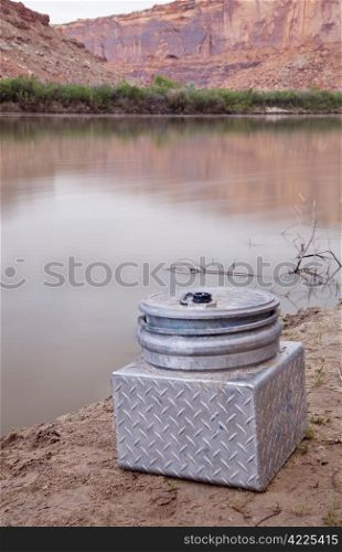 small metal portable toilet on a shore of Green River, equipment required on river trips in Canyonlands, Utah