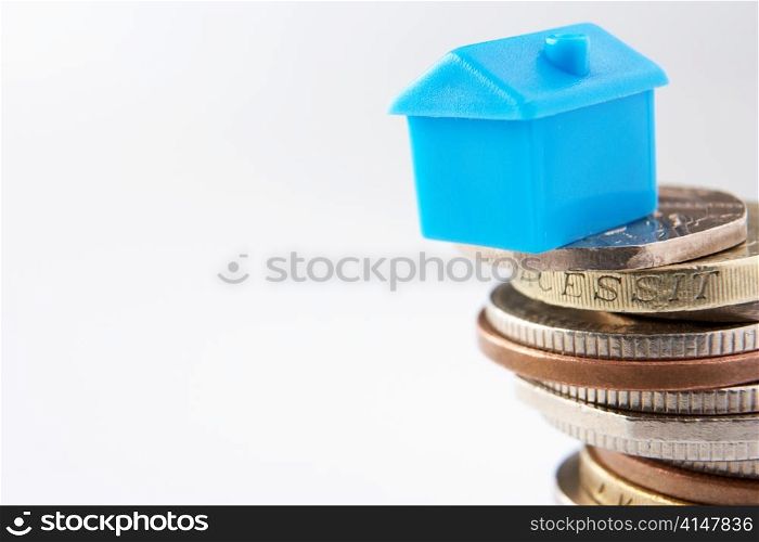 Small model house and coins