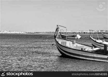 Small motor boats at the beach. Fishing Boats moored in the mediterranean sea in Israel. Black and White Picture