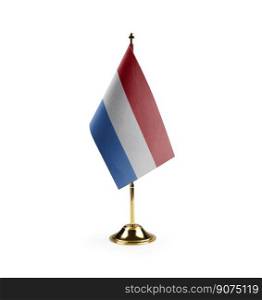 Small national flag of the Netherlands on a white background.. Small national flag of the Netherlands on a white background
