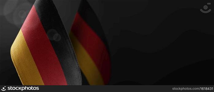 Small national flags of the Germany on a dark background.. Small national flags of the Germany on a dark background