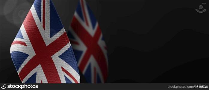 Small national flags of the United Kingdom on a dark background.. Small national flags of the United Kingdom on a dark background