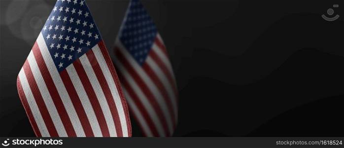 Small national flags of the United States on a dark background.. Small national flags of the United States on a dark background