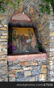 Small niche in stones with an icon in bottom.